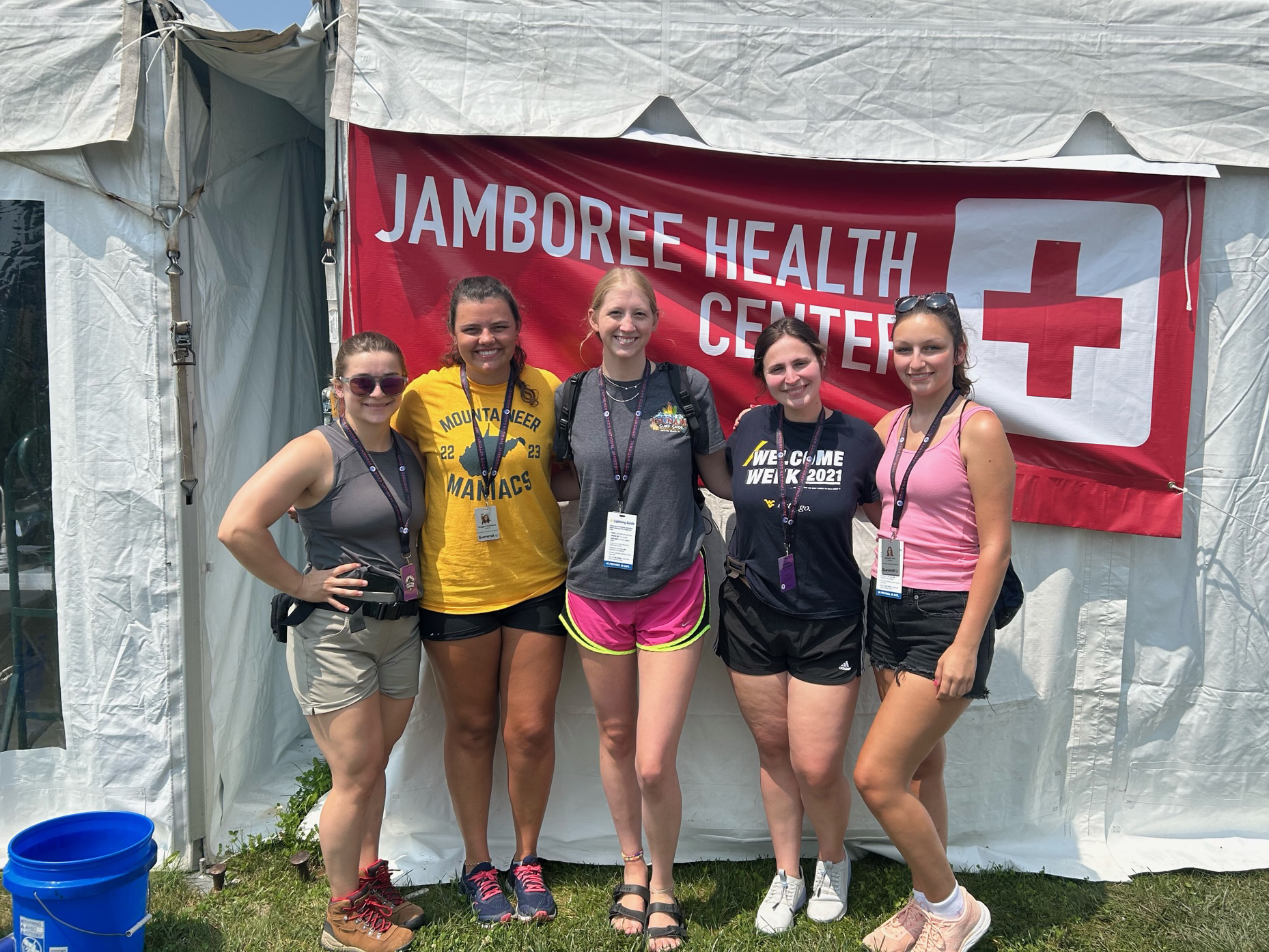 Five students stand in front of a white medical tent at the National Scouts Jamboree.